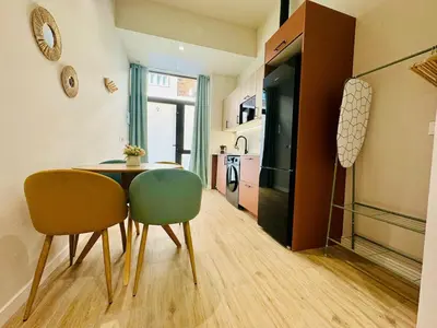 a room with a table and two chairs and a kitchen at Stylish Studio near City Center in Valencia