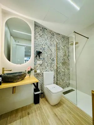 a bathroom with a toilet and a sink and a mirror at Stylish Studio near City Center in Valencia