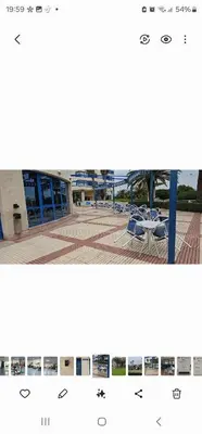 a picture of a building with a table and chairs at Playa La Patacona in Valencia