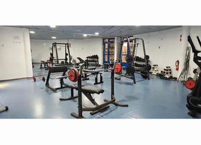 a gym with several tread machines in a room at Playa La Patacona in Valencia
