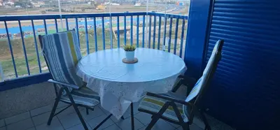 a table and two chairs on a balcony at Playa La Patacona in Valencia