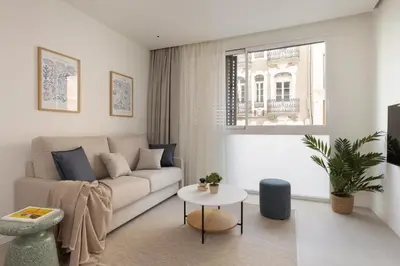 a living room with a couch and a table at Líbere Valencia Ruzafa in Valencia