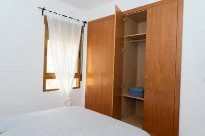 a bedroom with a bed and a wooden cabinet at Miralrio Chulilla in Chulilla