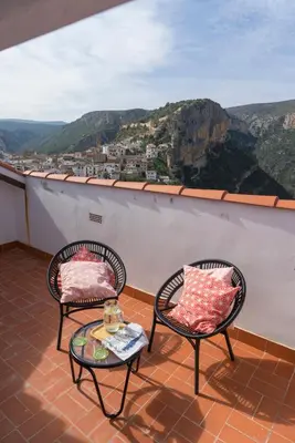 two chairs and a table on a balcony with a view at Miralrio Chulilla in Chulilla