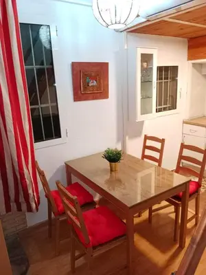 a dining room with a table with chairs and an american flag at Vacansis Chalet 3 Vedat in Torrent