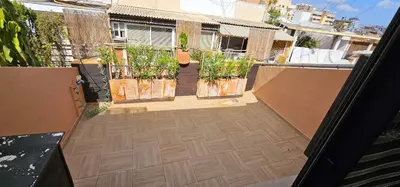 an open balcony with potted plants on a building at Vacansis Atico Loft El Mercat in Valencia