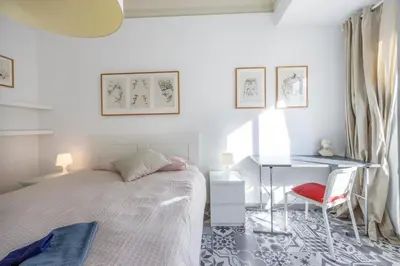 a white bedroom with a bed and a desk at Apartment Ruzafa 4 bedroom in Valencia