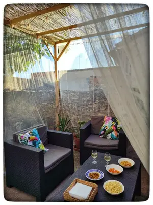 a patio with a table and chairs with food on it at Casa Maibeca in Bolbaite