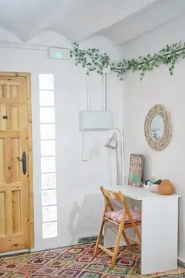 a room with a table and a chair next to a door at Casa Maibeca in Bolbaite