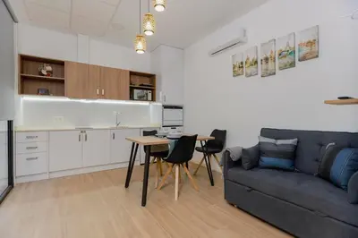 a living room with a couch and a table at Loft bien equipado - Lavavajillas, tostadora, secador, in Valencia