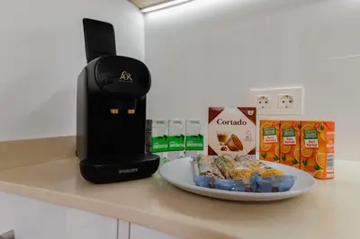 a coffee maker and a plate of food on a counter at Loft bien equipado - Lavavajillas, tostadora, secador, in Valencia