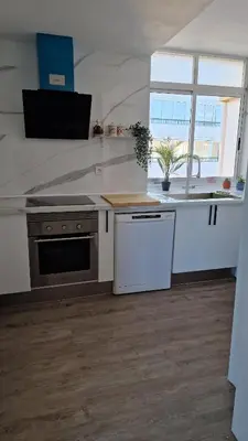 a kitchen with a sink and a stove at arena y mar in Tavernes de Valldigna