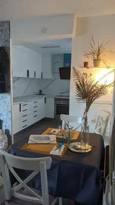 a kitchen with a table with a vase on it at arena y mar in Tavernes de Valldigna