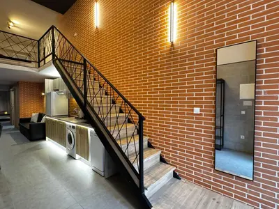 a staircase in a brick building with a washer and dryer at Cruilles 13 in Valencia
