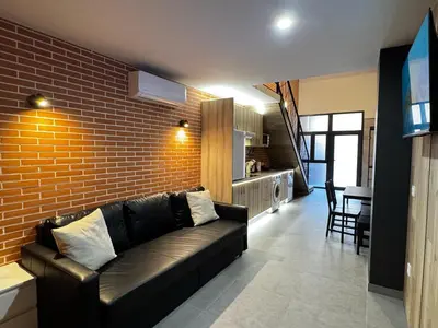 a living room with a couch and a brick wall at Cruilles 13 in Valencia
