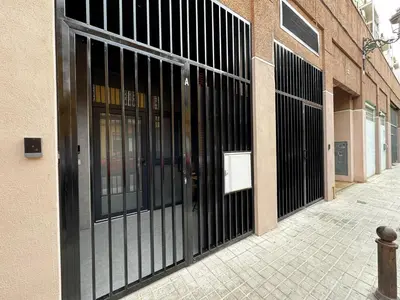 an entrance to a building with black metal doors at Cruilles 13 in Valencia