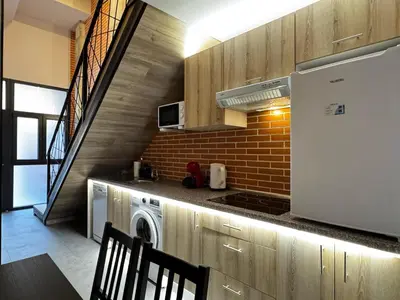 a kitchen with a stove and a washer and dryer at Cruilles 13 in Valencia