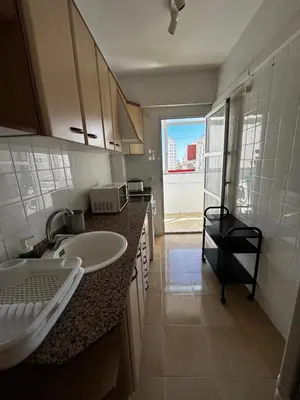 a small kitchen with a sink and a window at Amplio apartamento a 250 metros de la playa in Cullera