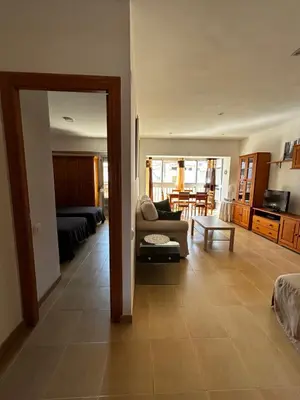 a balcony with two chairs and a view of a building at Amplio apartamento a 250 metros de la playa in Cullera