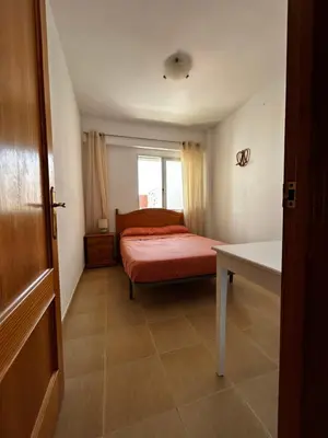 a white bathroom with a toilet and a sink at Amplio apartamento a 250 metros de la playa in Cullera