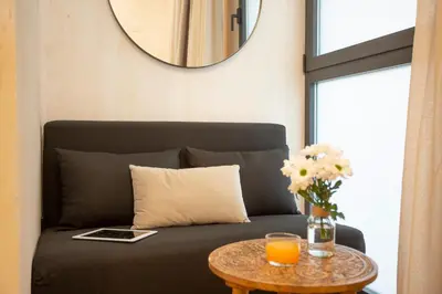 a living room with a couch and a table at Nomad Haux Mestalla Room 101 in Valencia