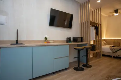 a kitchen with a counter with a tv on the wall at Nomad Haux Mestalla Room 101 in Valencia
