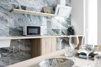 a kitchen with a table with a microwave on a shelf at PPA22 Loft Valencia - Acogedor loft cercano al metro Zona Ayora in Valencia