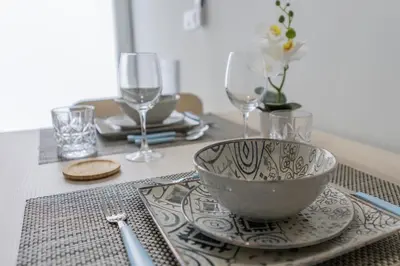 a table with a bowl on a plate and wine glasses at PPA22 Loft Valencia - Acogedor loft cercano al metro Zona Ayora in Valencia