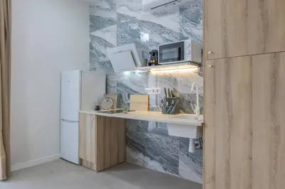 a kitchen with a counter and a refrigerator at PPA22 Loft Valencia - Acogedor loft cercano al metro Zona Ayora in Valencia