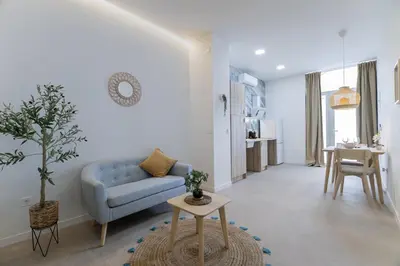 a living room with a blue couch and a table at PPA22 Loft Valencia - Acogedor loft cercano al metro Zona Ayora in Valencia