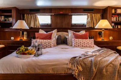 a bedroom with a bed with a bowl of fruit on it at Hotel Yacht Our Alissa in Valencia