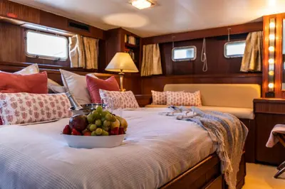 a bed with a bowl of fruit on it at Hotel Yacht Our Alissa in Valencia