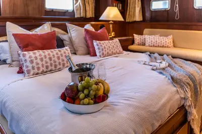 a bed with a bowl of fruit on it at Hotel Yacht Our Alissa in Valencia