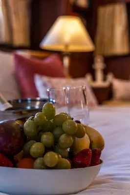 a bowl of grapes and strawberries on a table at Hotel Yacht Our Alissa in Valencia