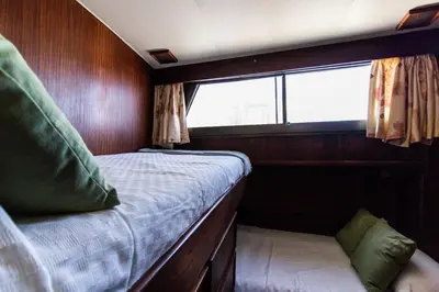 a bed in the back of a boat with a window at Hotel Yacht Our Alissa in Valencia