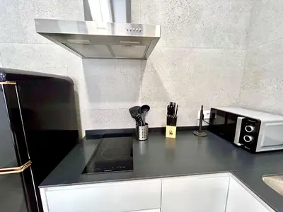 a kitchen counter with a microwave and a stove at Valencia Getaway - Jacuzzi, Space & Comfort in Valencia
