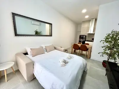 a small room with a bed and a couch at Valencia Getaway - Jacuzzi, Space & Comfort in Valencia