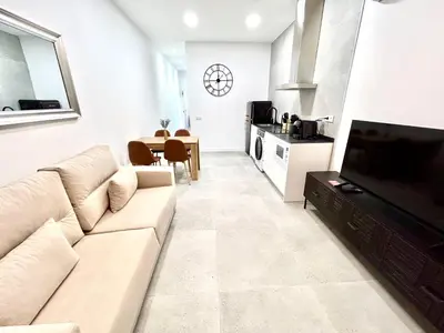a living room with a couch and a dining room at Valencia Comfort Stay Near Metro, 2 Bed, 1 Bath in Valencia