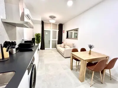 a kitchen and living room with a table and a couch at Valencia Comfort Stay Near Metro, 2 Bed, 1 Bath in Valencia