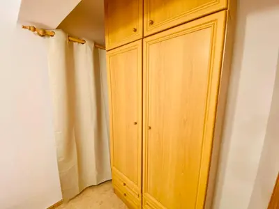 a wooden cabinet in a corner of a room at Batflats-Palmeres Playa in Sueca