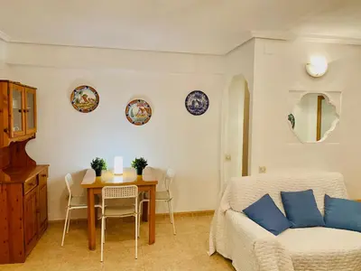 a living room with a table and a couch at Batflats-Palmeres Playa in Sueca