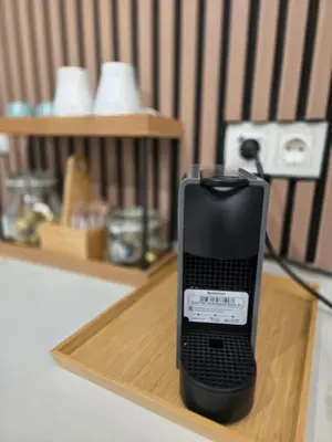a black phone is sitting on a wooden tray at eXperience Apartment Valencia in Valencia