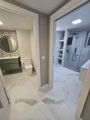 a bathroom with a sink and a toilet and a mirror at eXperience Apartment Valencia in Valencia