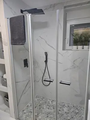 a bathroom with a shower with a glass door at eXperience Apartment Valencia in Valencia