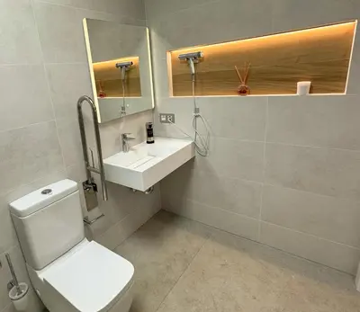 a bathroom with a toilet and a sink and a mirror at Apartamento céntrico cerca de Torres de Serrano y Viveros in Valencia