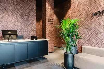 an office with a desk and plants in a room at Hotel Arena Select in Valencia