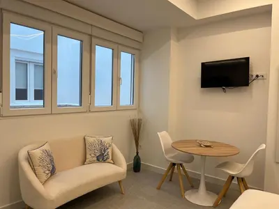 a living room with a couch and a table at Apartments Vent de Vela in Valencia