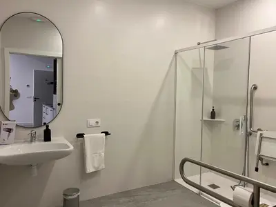 a white bathroom with a sink and a mirror at Apartments Vent de Vela in Valencia