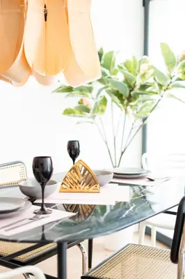 a dining room table with a glass table top at PV Loft Valencia - Modernos y cómodos estudios dúplex cerca a Russafa in Valencia
