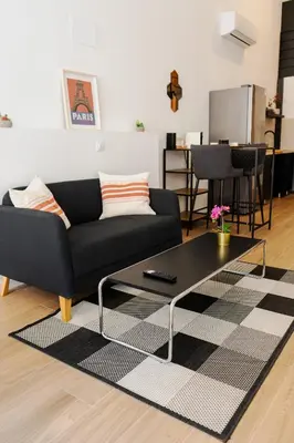 a living room with a couch and a coffee table at PV Loft Valencia - Modernos y cómodos estudios dúplex cerca a Russafa in Valencia